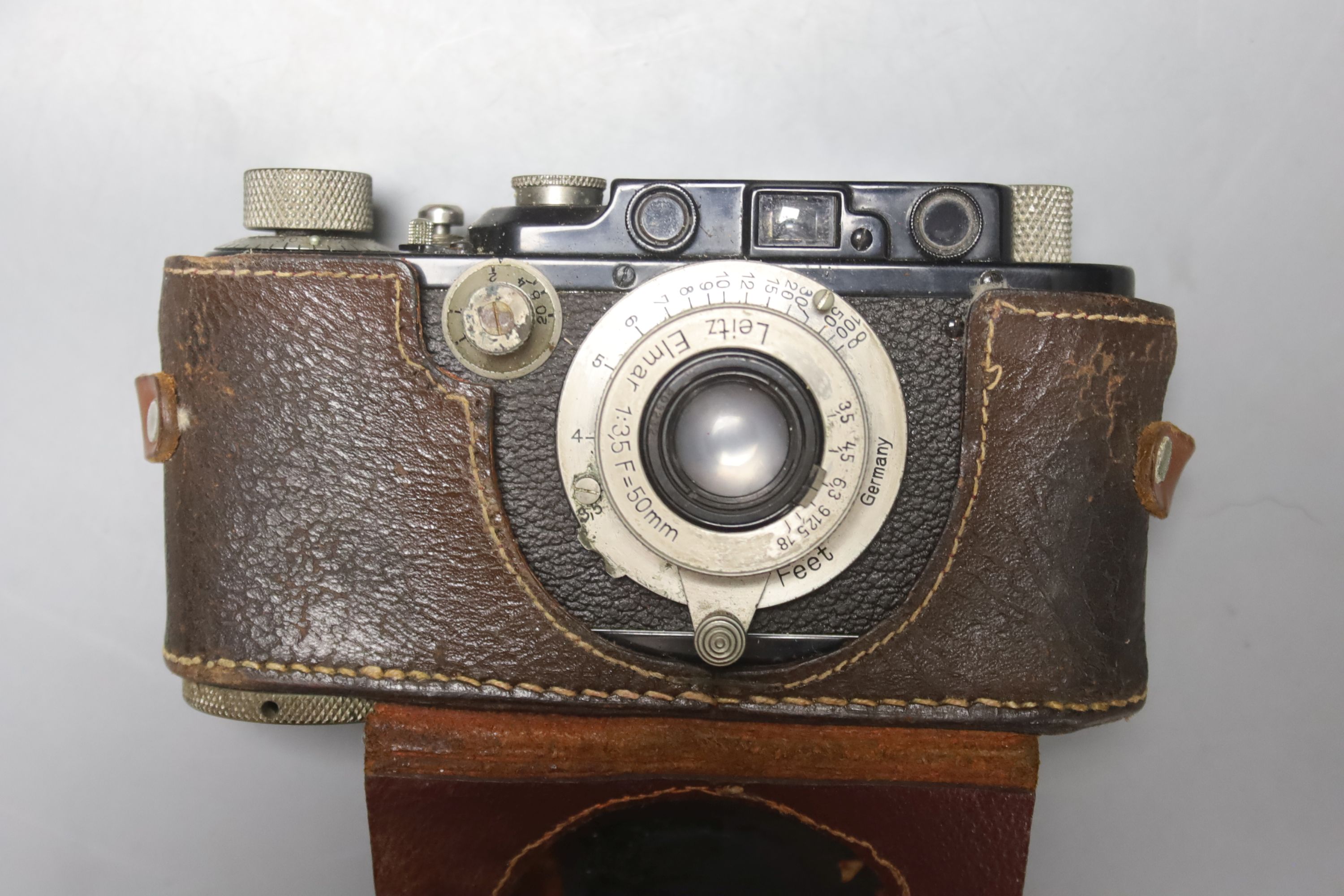 A Leica standard camera, number 145405 (1934), with leather case and a book